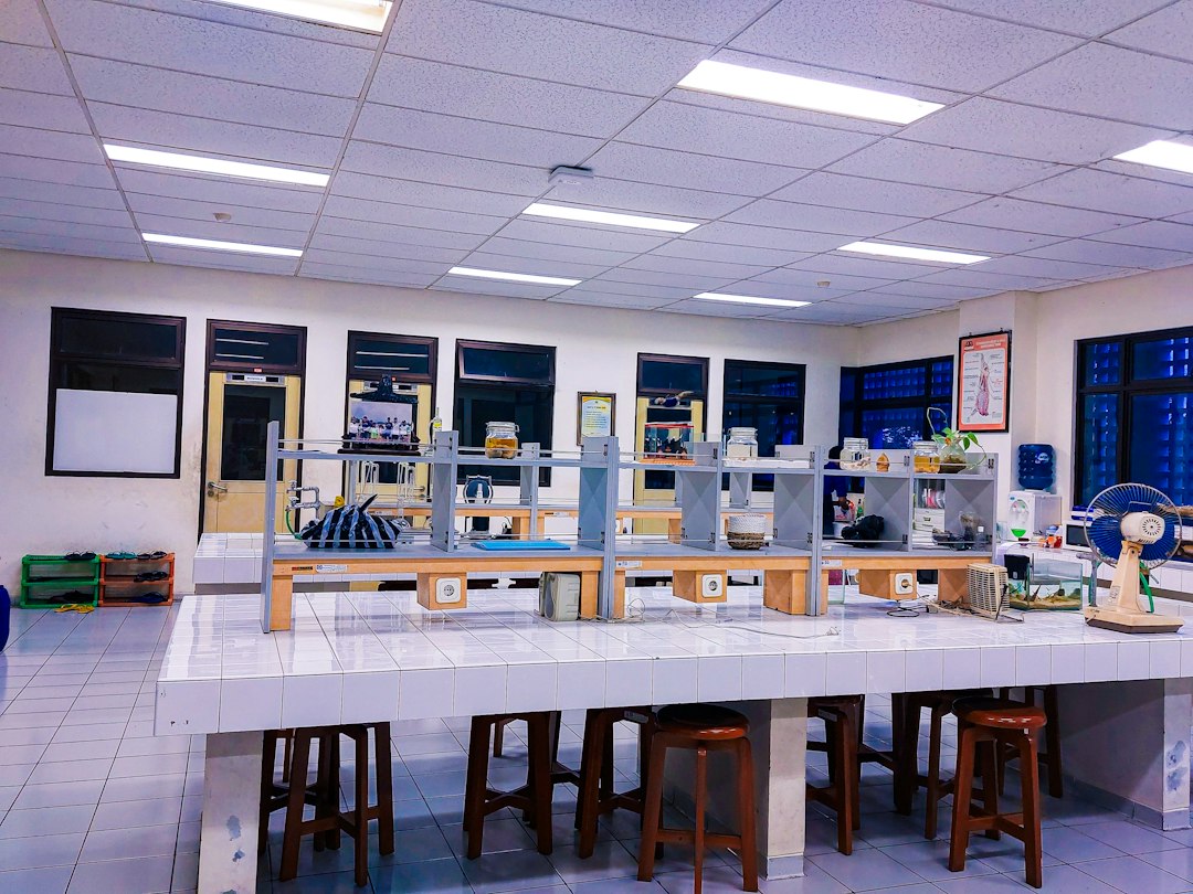A pharmacy teaching laboratory with student benches and equipment