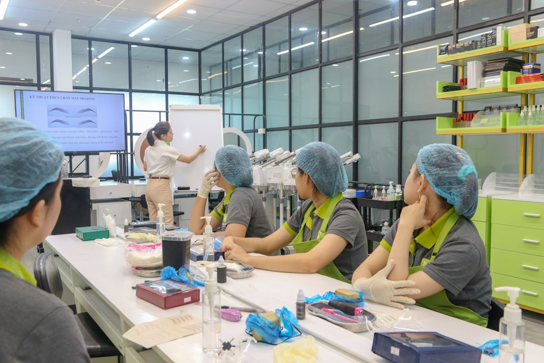 A group of students in a hands-on training session, working through a practical exercise with an instructor
