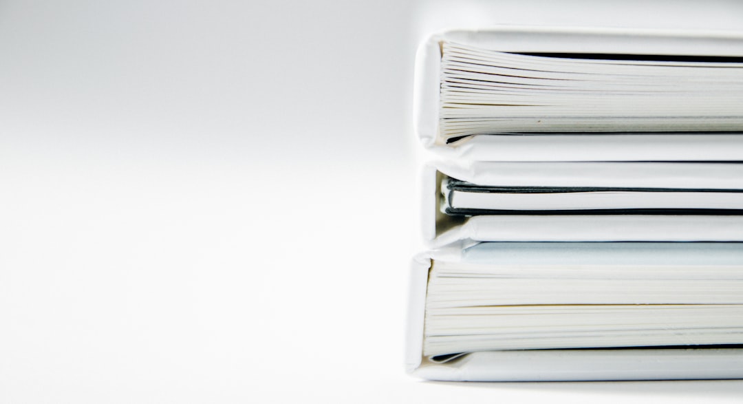 Stack of thick folders — representing the faculty evidence submissions that coordinators manage