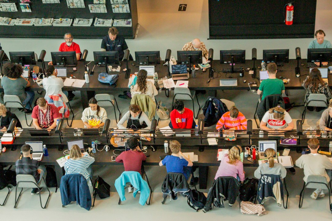Students working at desks in a university lecture hall