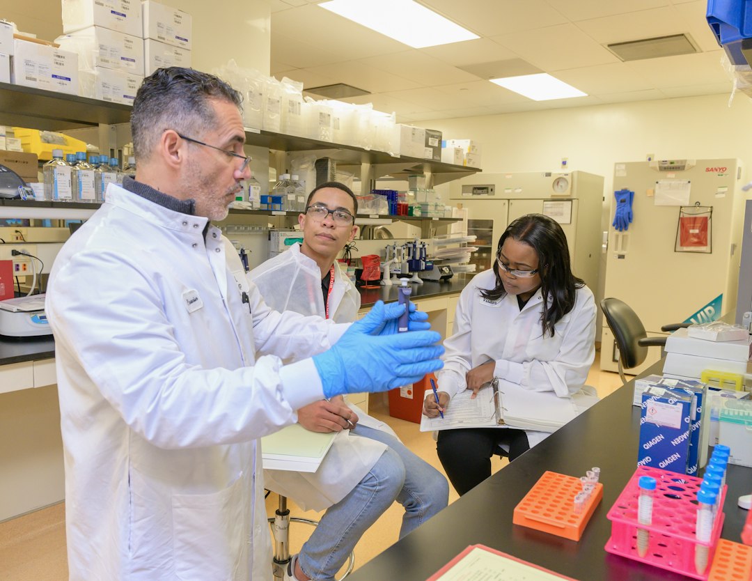 A faculty member supervising pharmacy students working in a laboratory