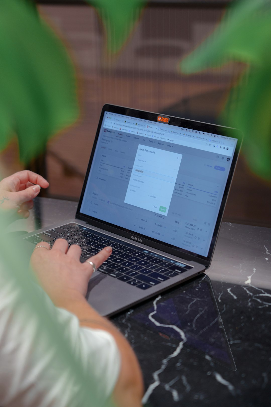 An accreditation coordinator working through a software interface on a laptop, the primary user of the tool