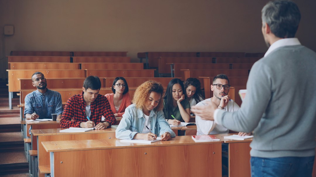 A professor lecturing to pharmacy students in a classroom, where each course's learning outcomes are mapped to program standards