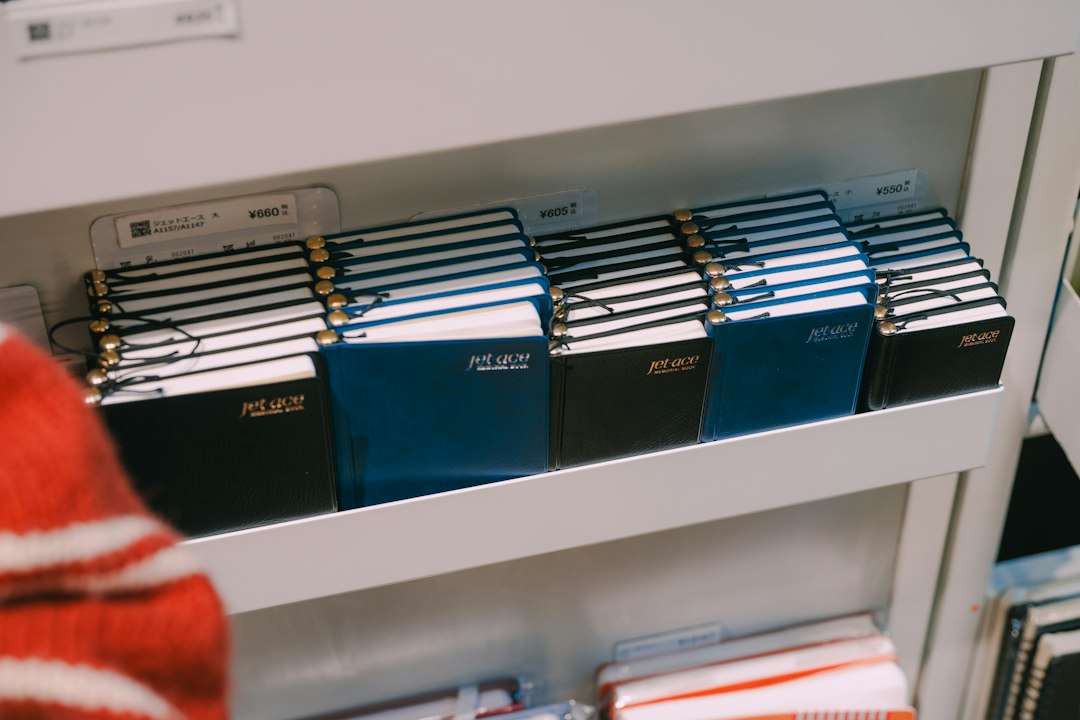 A row of notebooks lined up on a shelf