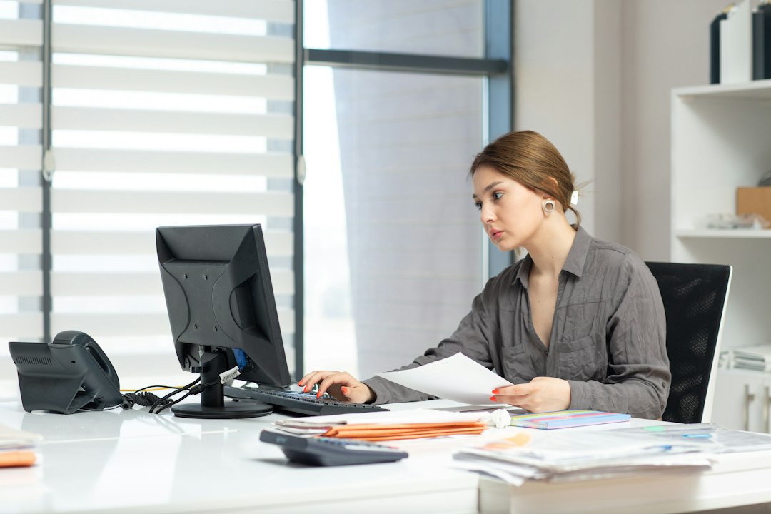 A professional organizing accreditation records at a desk