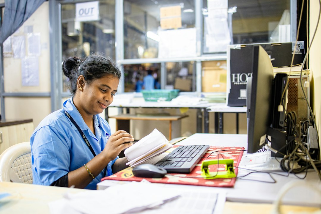 A coordinator reviews a stack of practice-experience documents at a desk.
